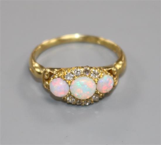 An Edwardian 18ct gold, white opal and diamond cluster ring, size M.